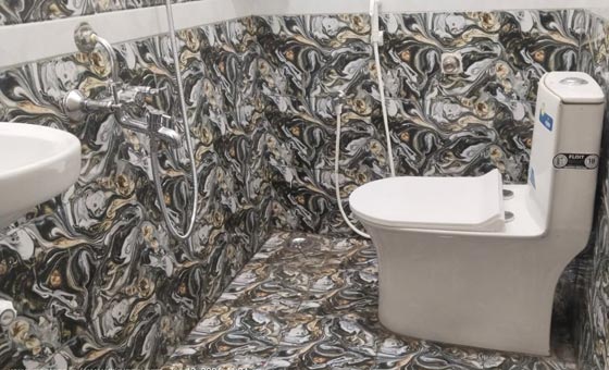 Spotless attached bathroom featuring modern tiling, western toilet, and high maintenance standards.